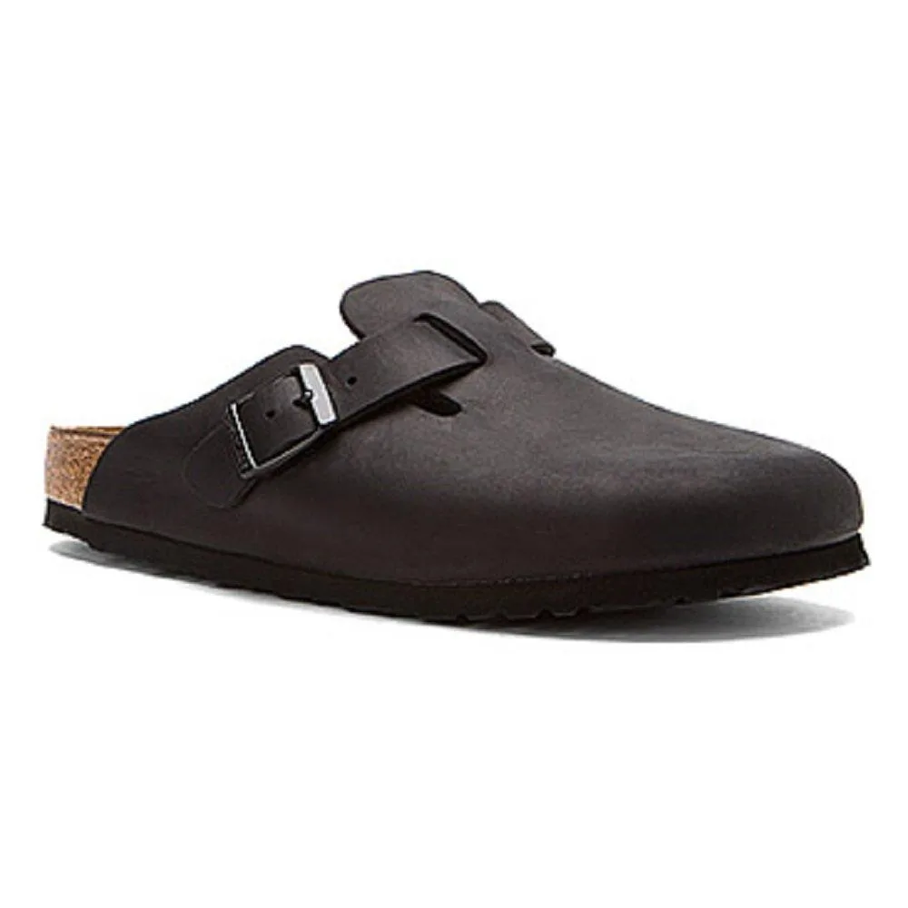 Black oiled leather clog with adjustable metal buckle strap and contoured cork footbed
