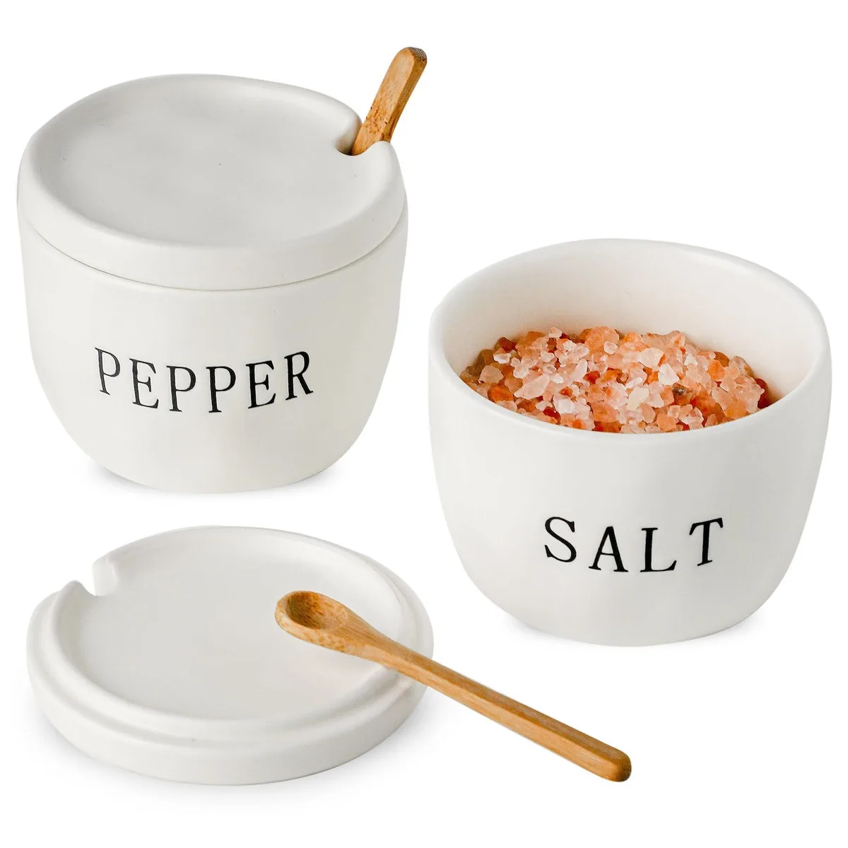 Two matte white ceramic salt and pepper bowls with lids and wooden spoons