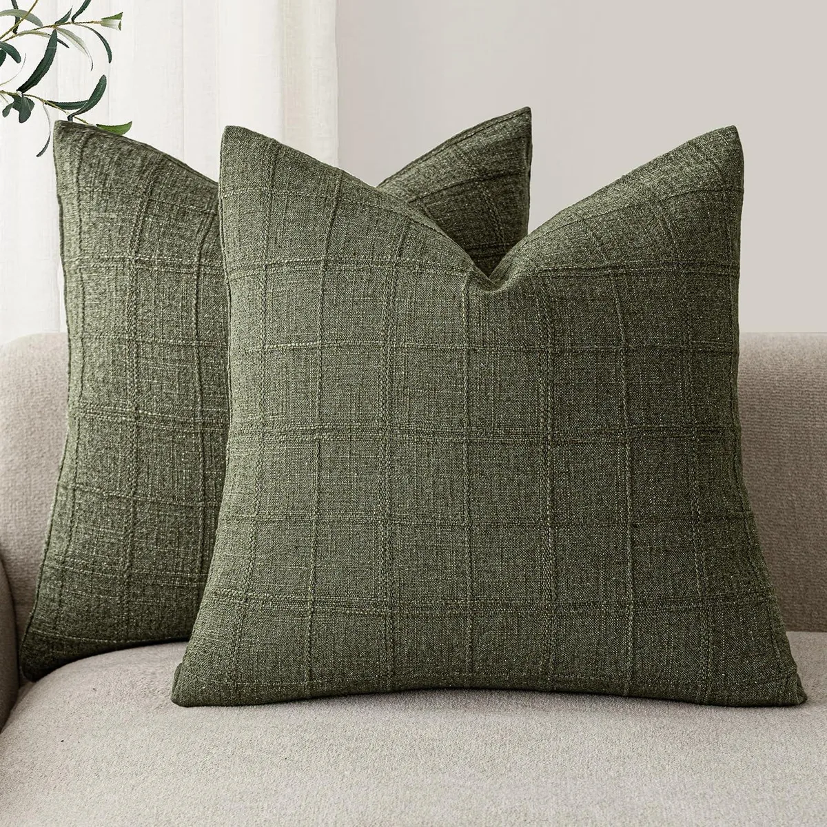 Two olive-green linen pillow covers with a checkered pattern, square, 20 by 20 inches