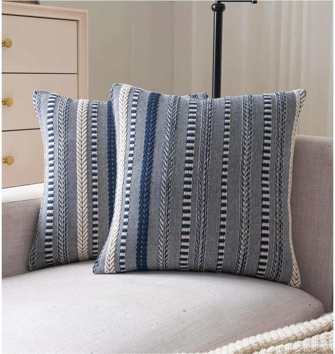 Two square navy-blue cotton pillow covers with woven stripes and invisible zippers, 18 by 18 inches