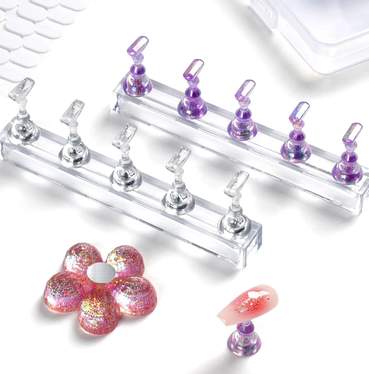 Black plastic nail stand kit with two transparent rectangular bases, one floral base, eleven chess-shaped tips, and a storage box