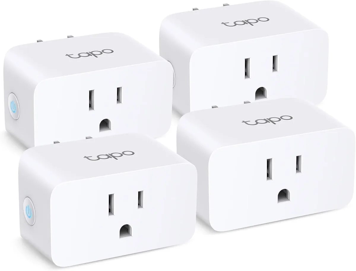 Four compact white smart plugs with UK pins