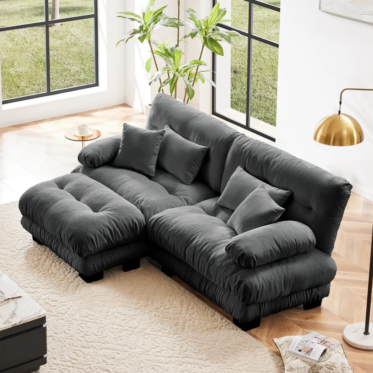 Gray chenille two-seater sectional with wide round bolster arms, convertible ottoman and four accent pillows