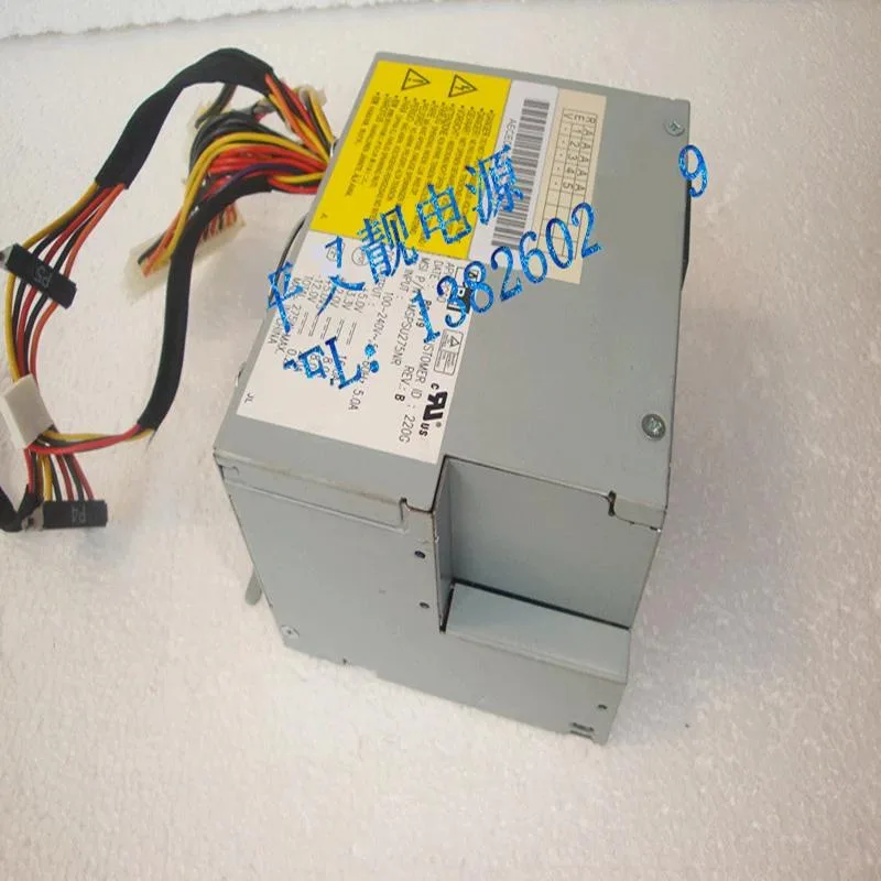 Rectangular black metal ATX power supply unit with fan grille and label showing 275W