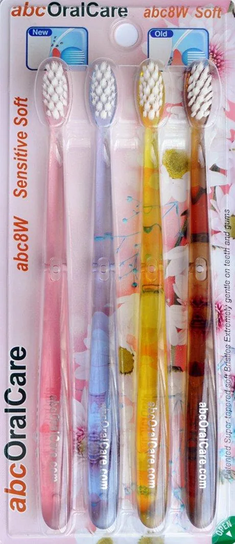 Four white manual toothbrushes with tapered ultra-fine bristles