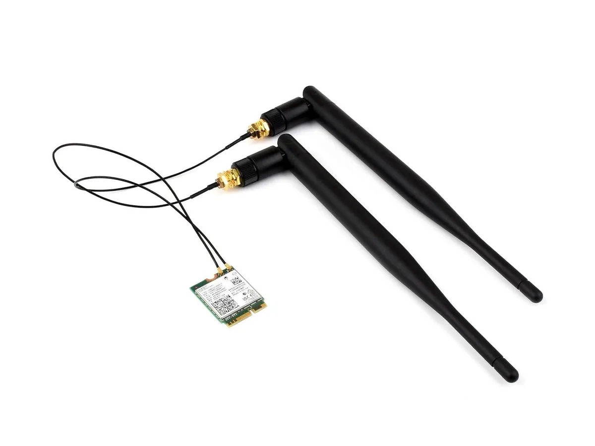 Small rectangular circuit board with gold edge connector and black antenna connectors