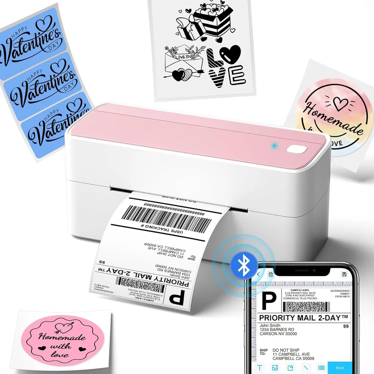 Pink rectangular thermal label printer with USB cable and label roll visible