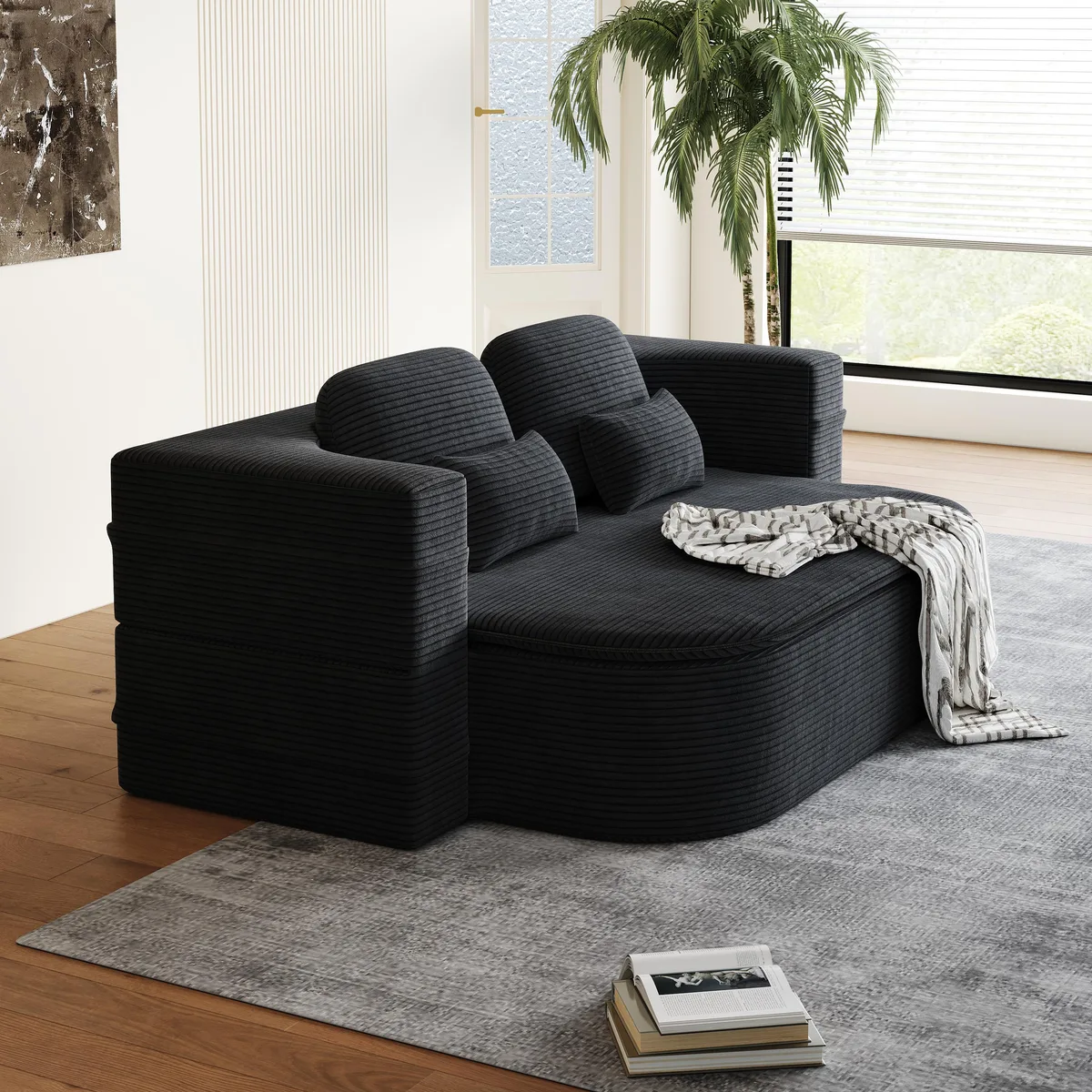 Black corduroy foldable floor sofa shown open as a lounge bed with pillows