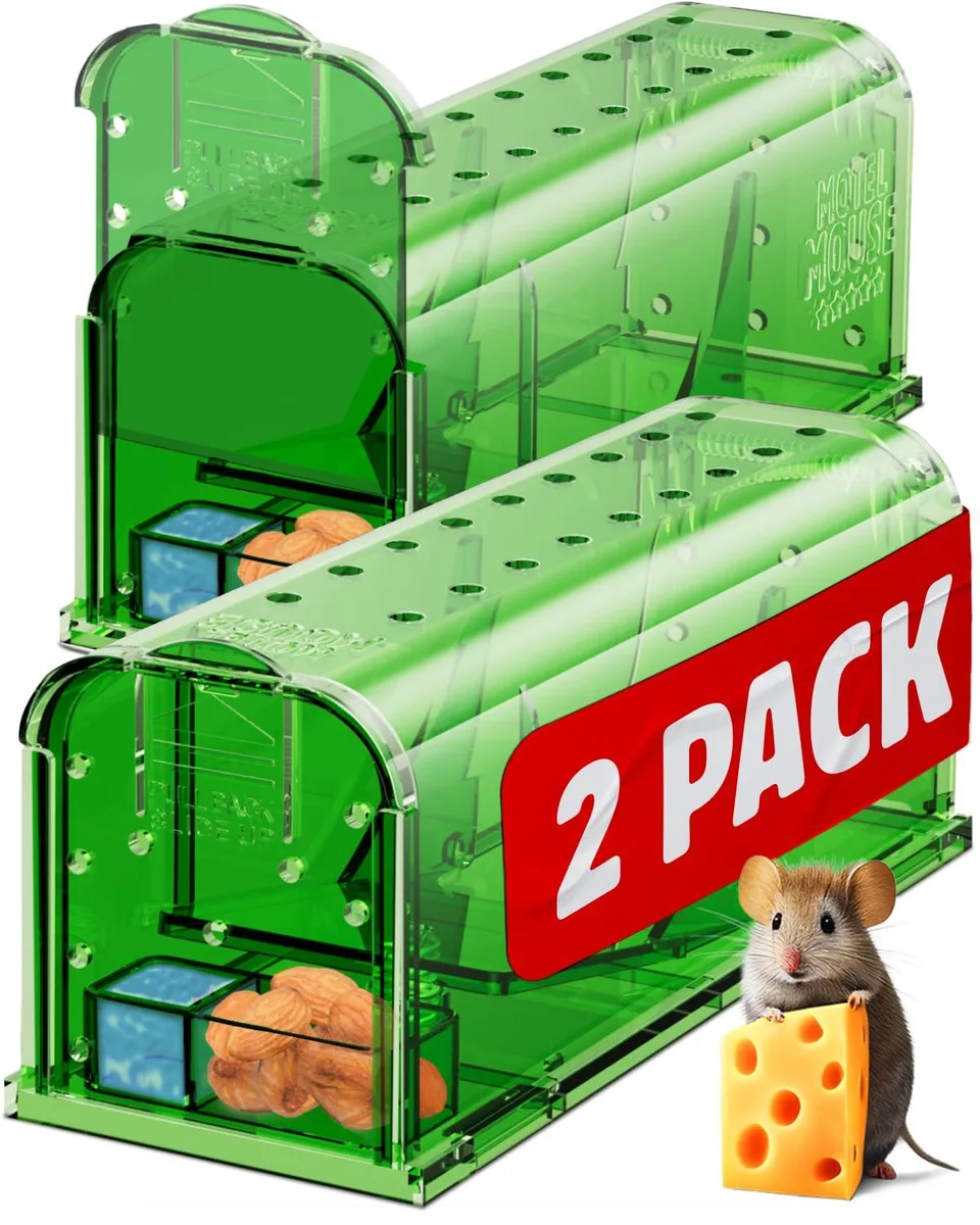 Two green plastic humane mouse traps with air holes and release doors