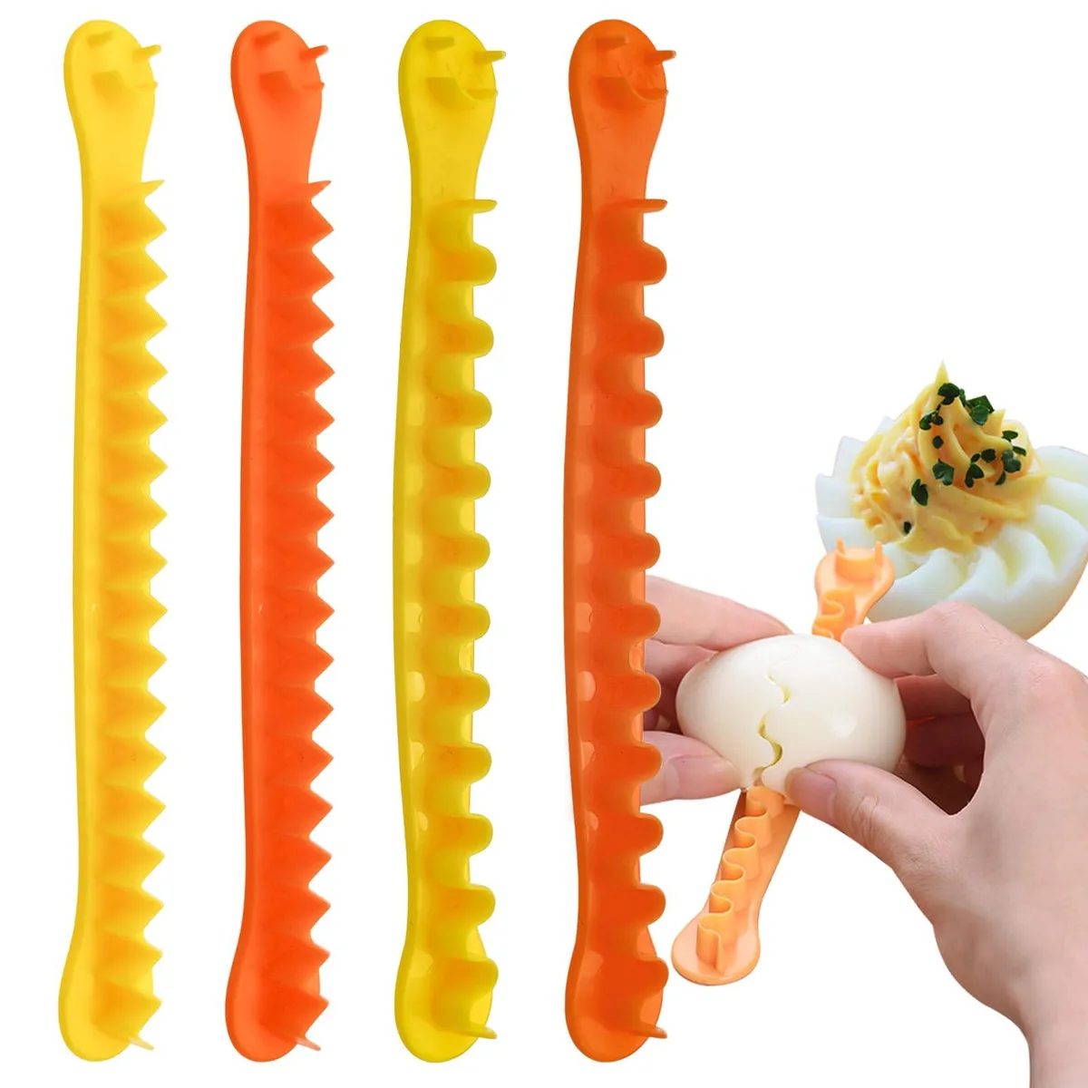 Four orange plastic egg cutters, two flower shapes and two semicircle shapes