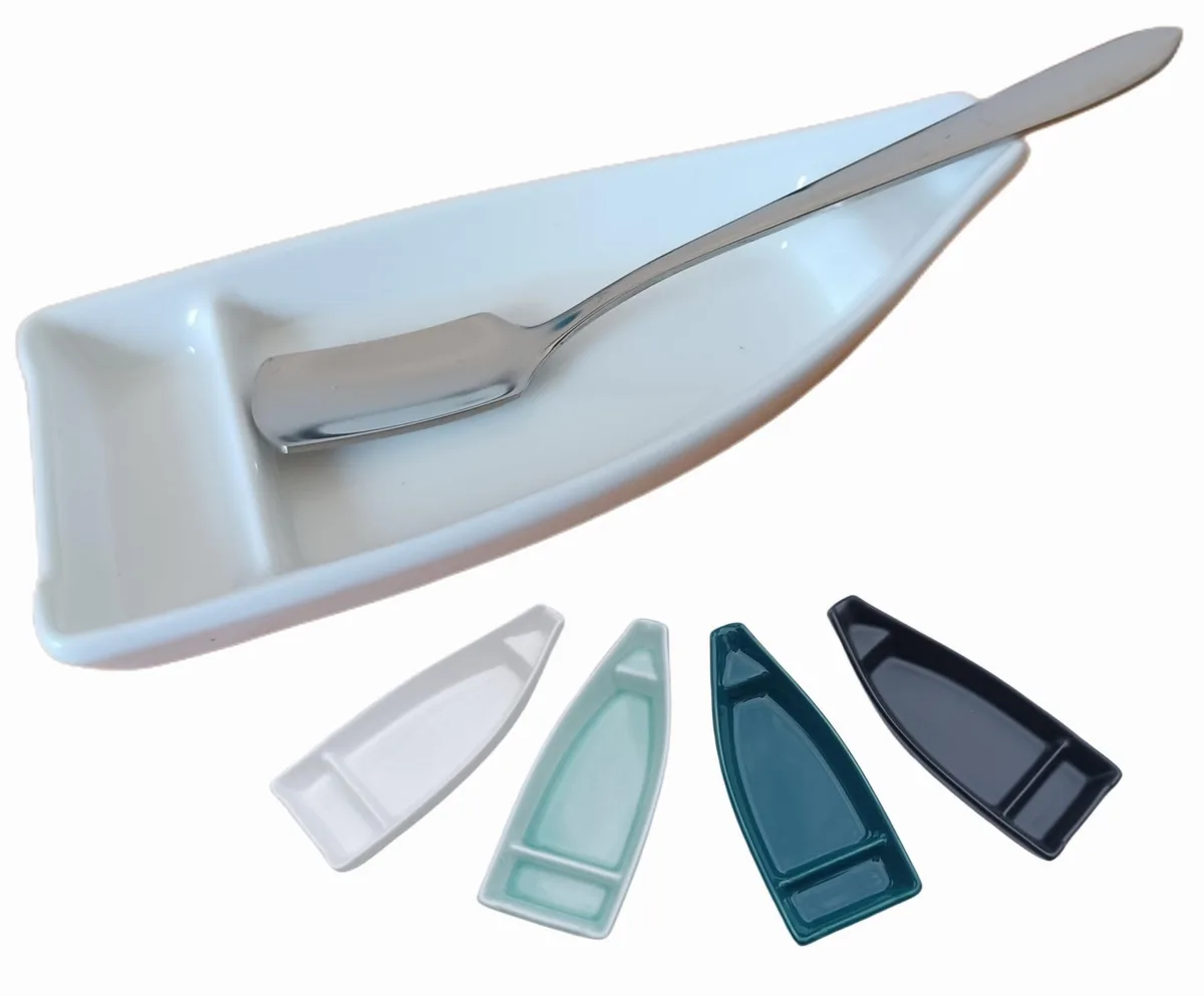 White ceramic boat-shaped rest with stainless steel oar spoon