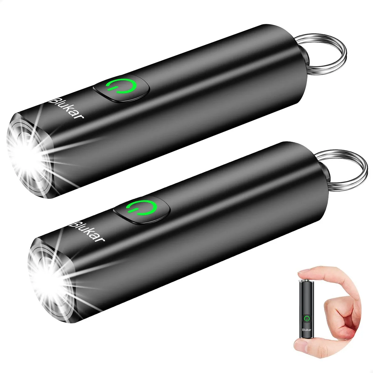 Two tiny cylindrical aluminium key-ring lights, matte dark finish, side USB-C ports