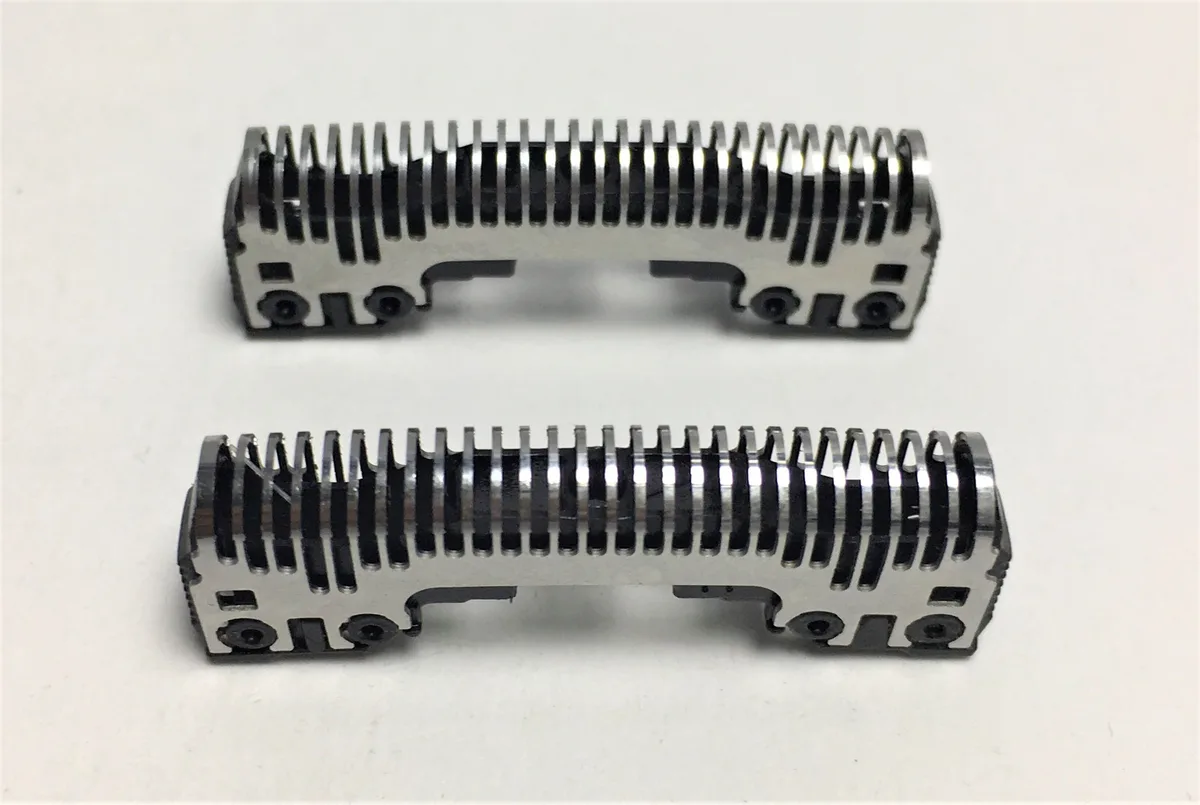 Two silver foil shaver heads with inner blades on white background