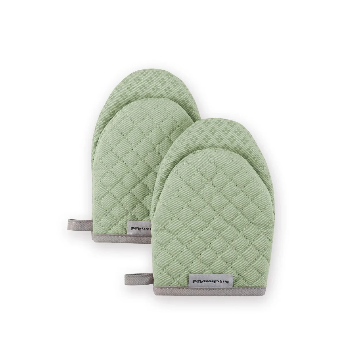 Two pistachio-green cotton mini mitts with textured silicone grips, 5.5 by 8 inches