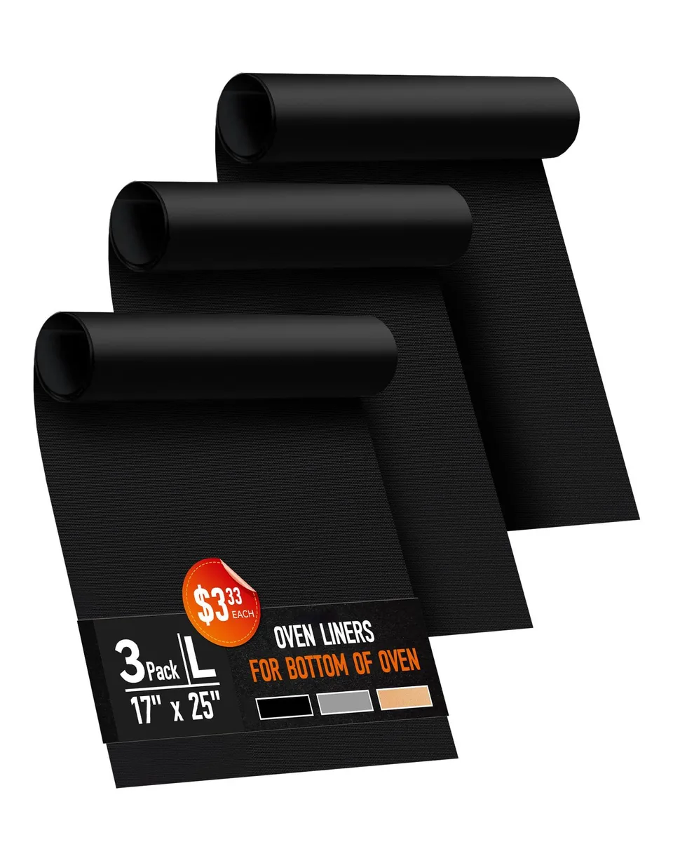 Three black rectangular oven liners stacked flat