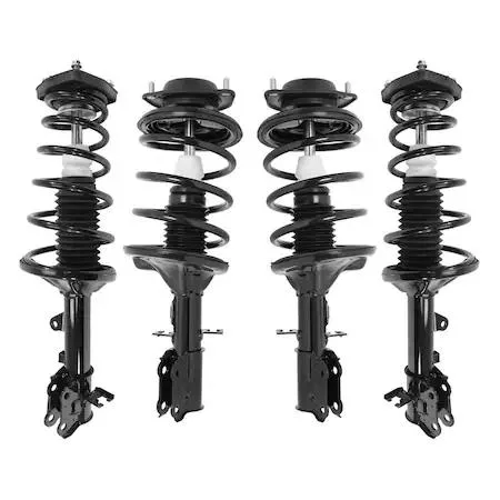 Four silver strut assemblies with coiled springs and top mounts laid out on a light background
