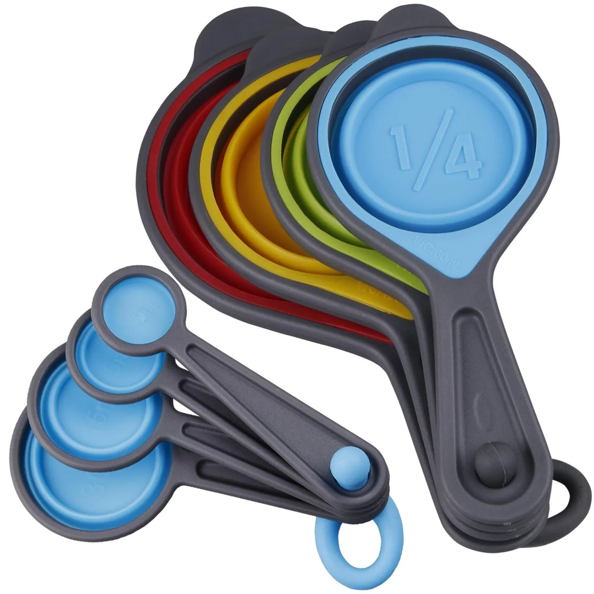 Eight collapsible silicone cups and spoons in rainbow colours, nested together