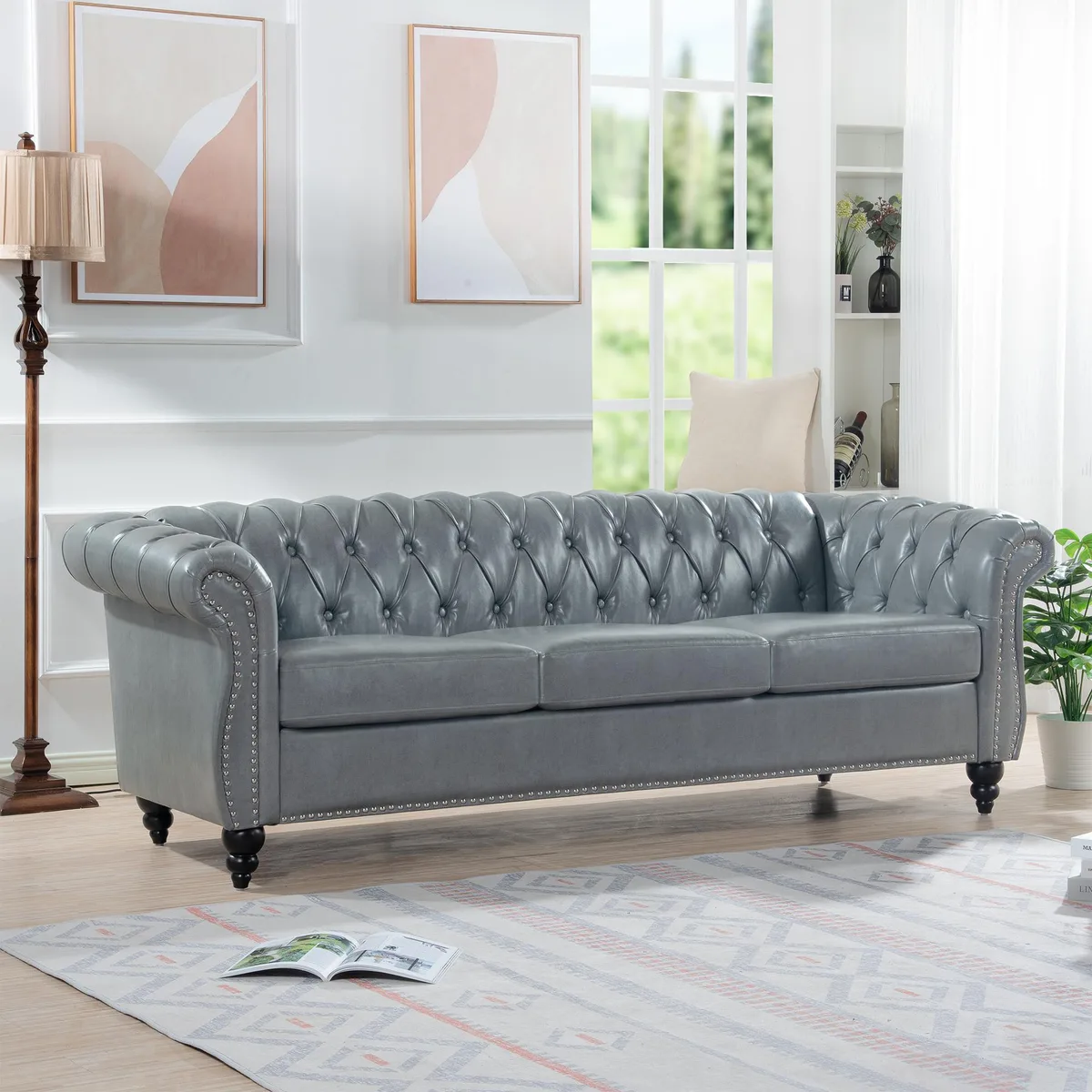 Grey rolled-arm Chesterfield three-seater sofa with deep button tufting and birch legs