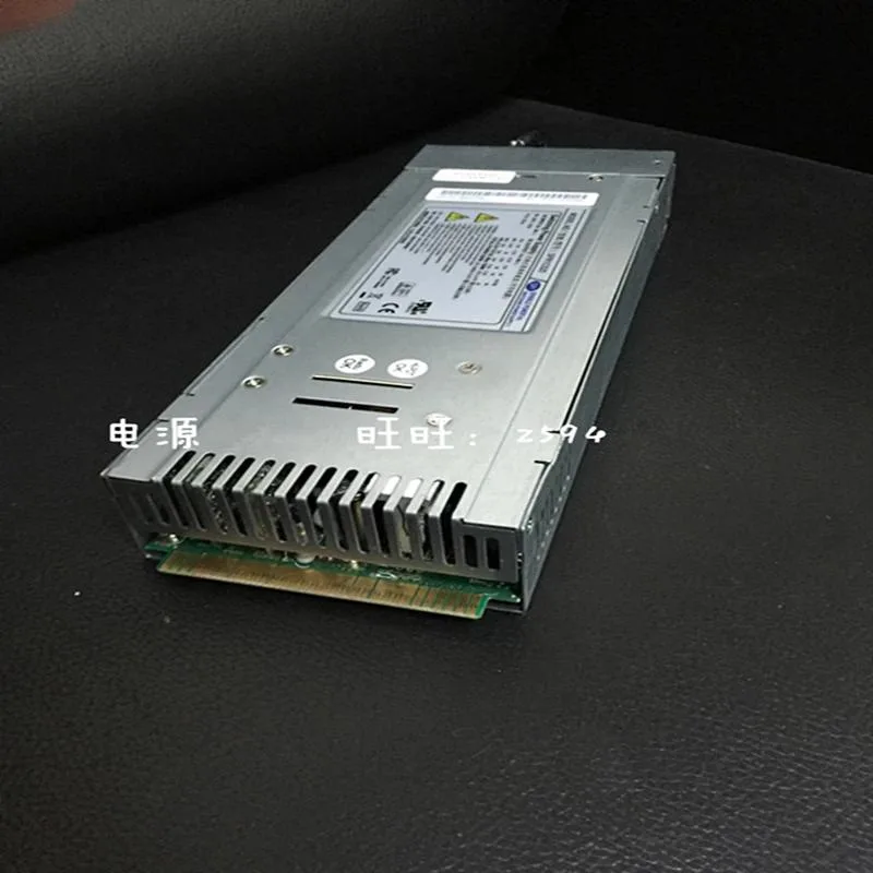 Rectangular silver ATX power supply unit with fan grille