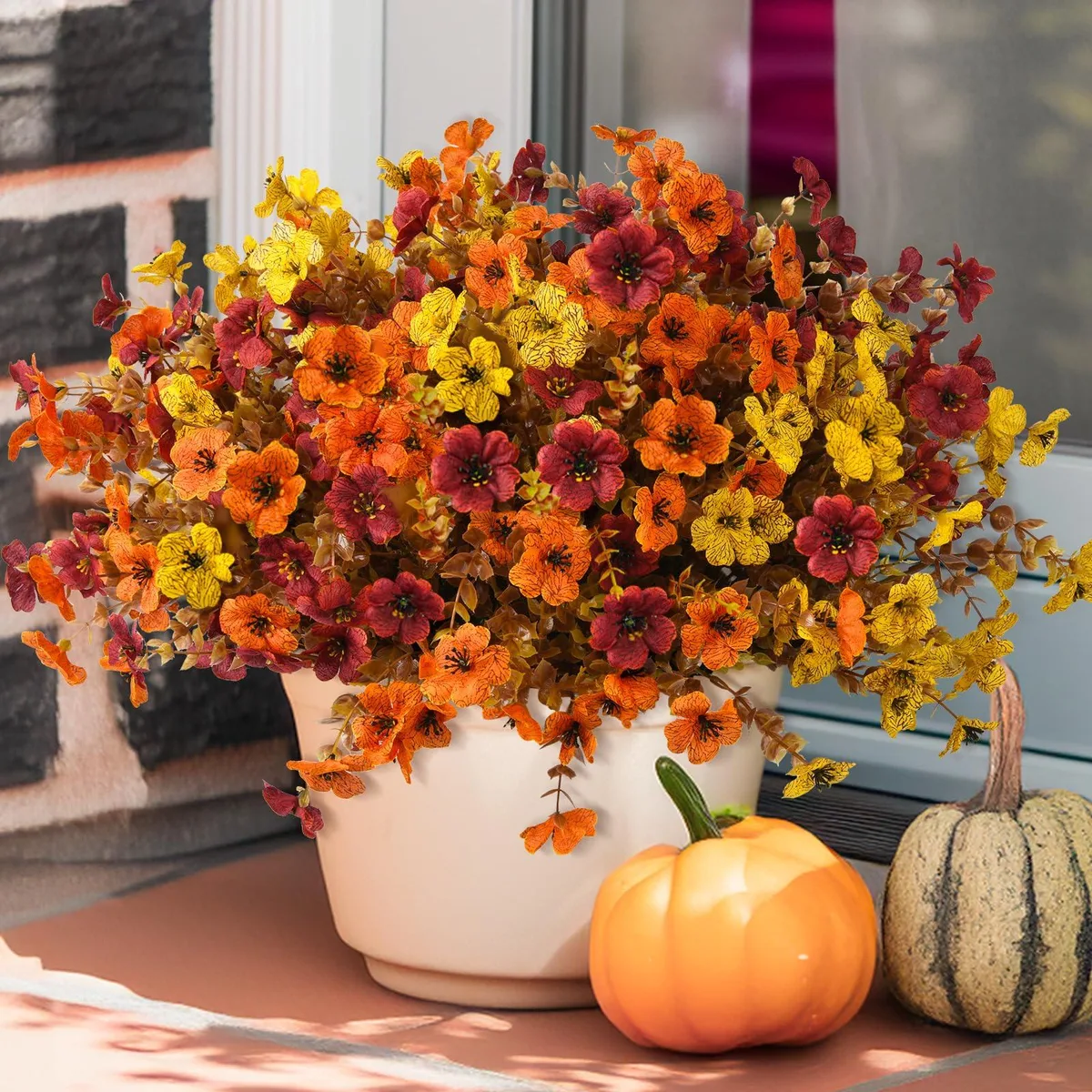 Twelve brown daisy bundles with green leaves in a planter