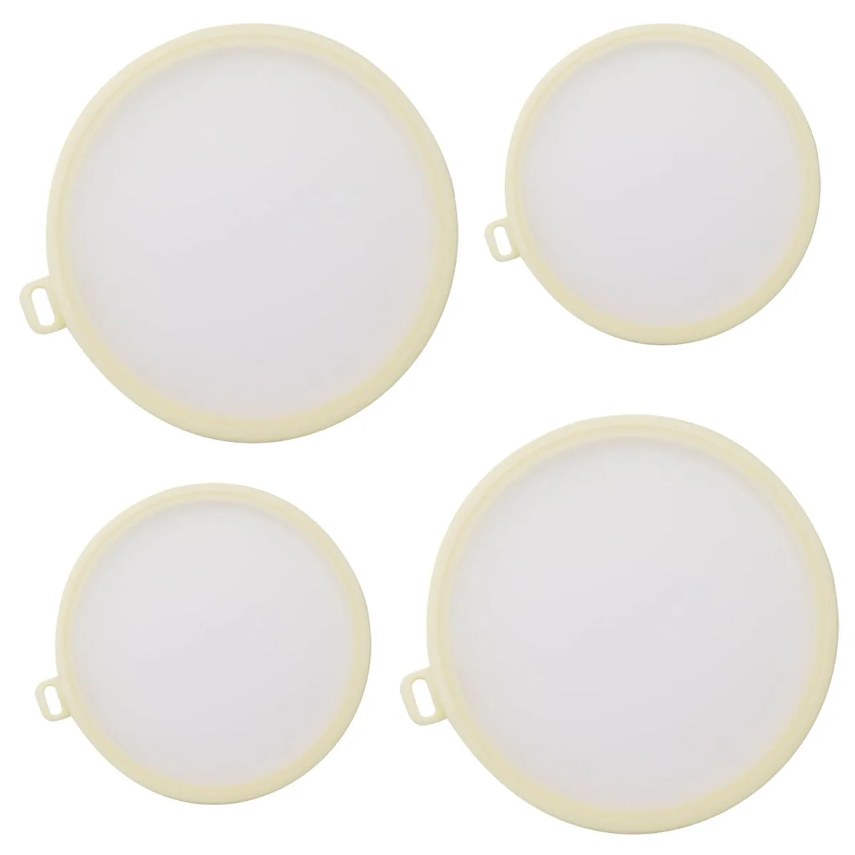 Four white silicone food covers with suction seal design