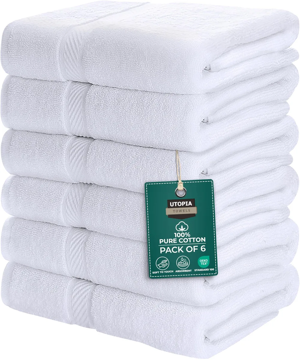 Six white cotton bath towels stacked, 22 by 44 inches each