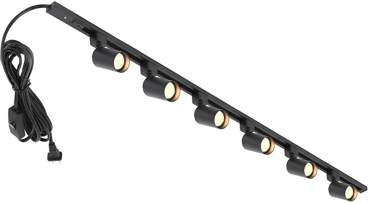 Black metal track lighting kit with six adjustable heads on two rails and a long power cord