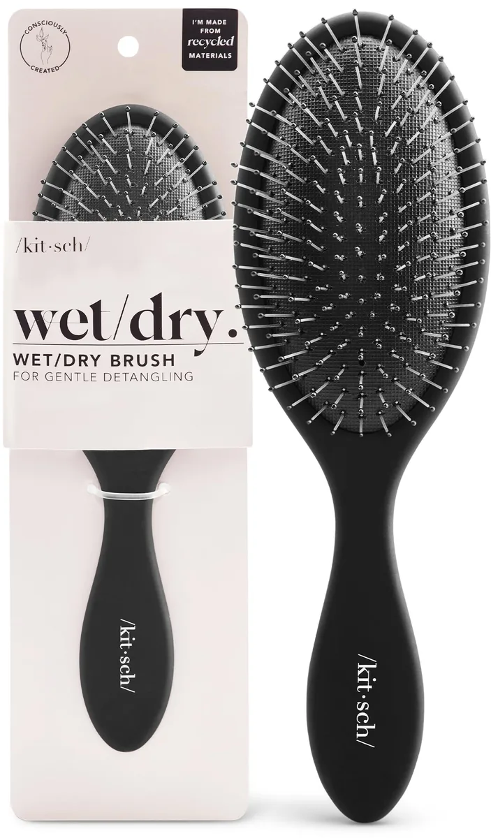 Black flexible detangling brush with curved handle and recycled plastic bristles