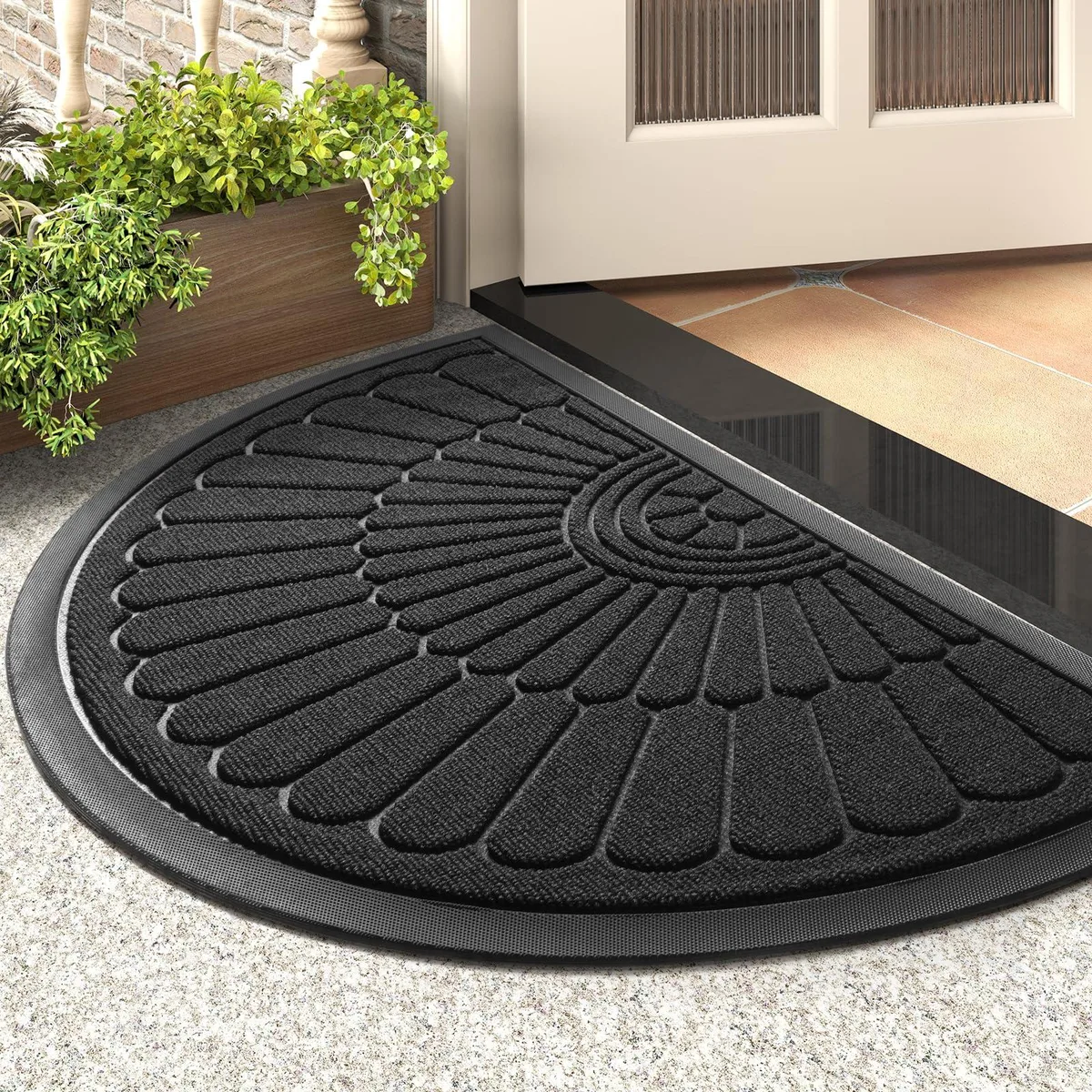 Black semicircular door mat, flat rubber-backed textile with ribbed surface, 17 by 30 cm