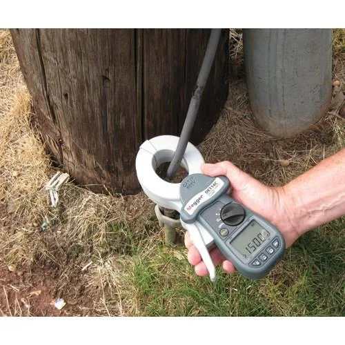 Handheld clamp earth resistance tester with grey plastic body, spring-loaded jaws and LCD display
