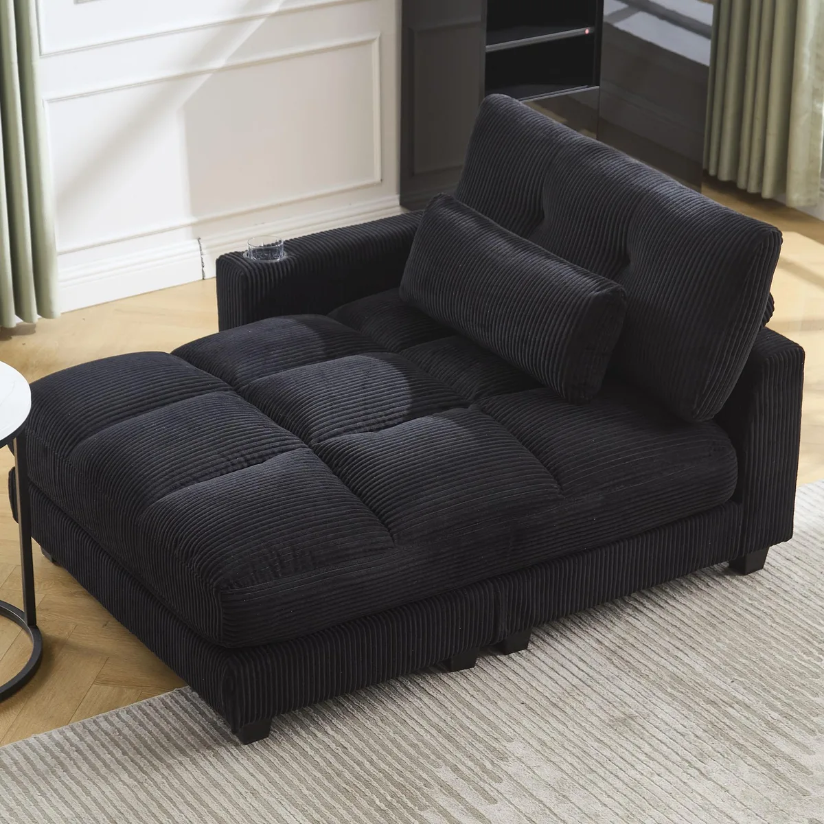 Black corduroy sleeper sofa with reversible armrest, cup holder and side pocket