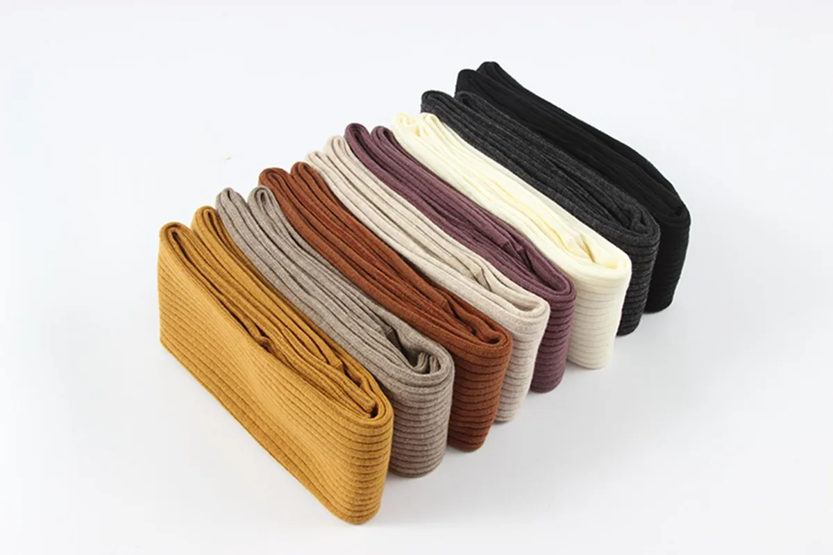 Four pairs of thigh-high cotton boot socks in tan, purple, beige and turmeric
