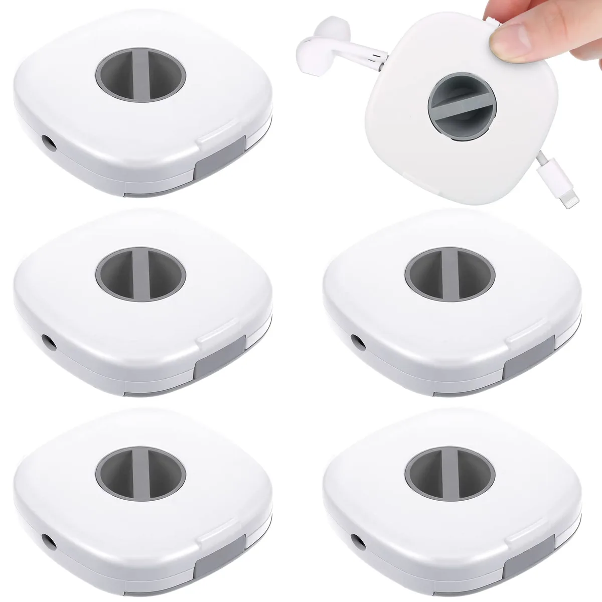 Six small white rectangular ABS plastic cable winders with central knobs, each about 2.8 by 2.7 by 0.1 inches, shown together