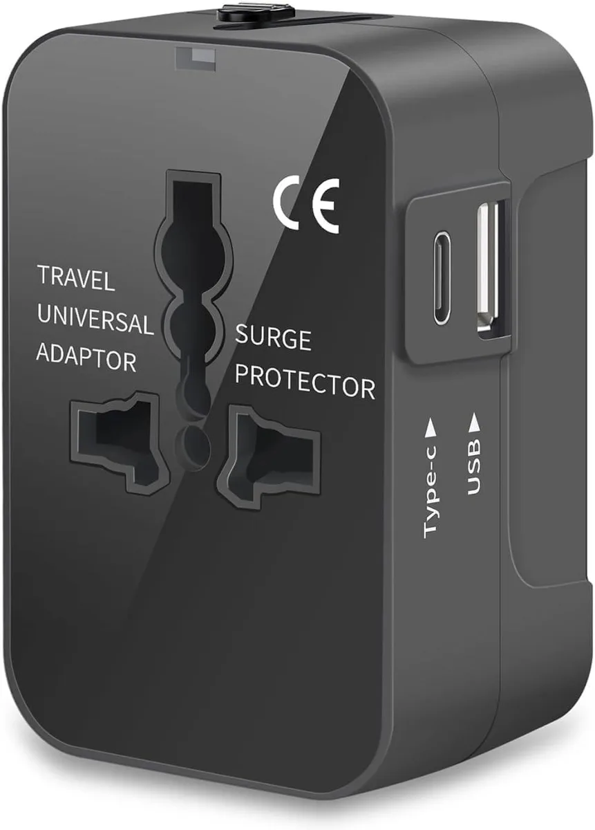 Black rectangular universal travel adapter with sliding plug mechanism, Type-C and USB-A ports, and LED indicator