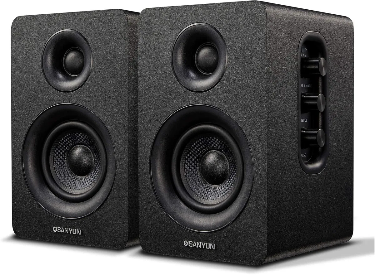 Pair of compact black bookshelf speakers with side control knobs