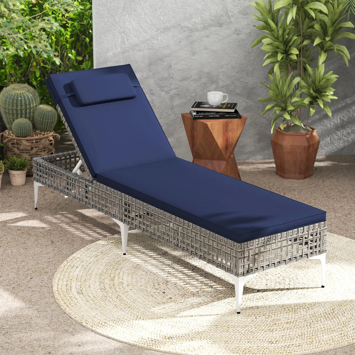 Navy cushion chaise lounge with grey wicker frame and adjustable backrest