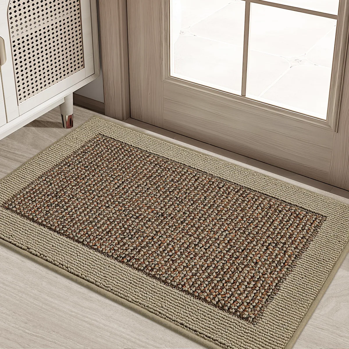 Rectangular taupe door mat, low-profile woven surface with reinforced edges, flat on light floor