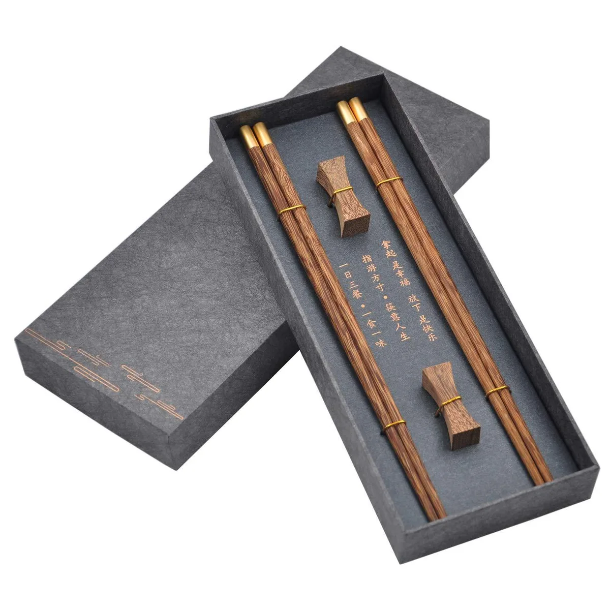 Two pairs of dark wenge wood chopsticks with metal tips and a matching rest in a gift box