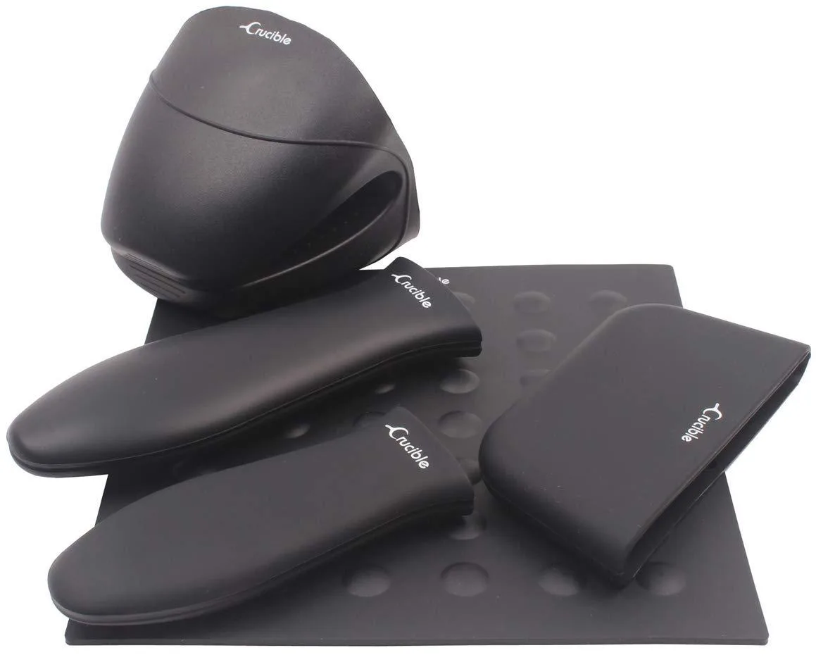 Five black silicone handle sleeves and accessories on a surface