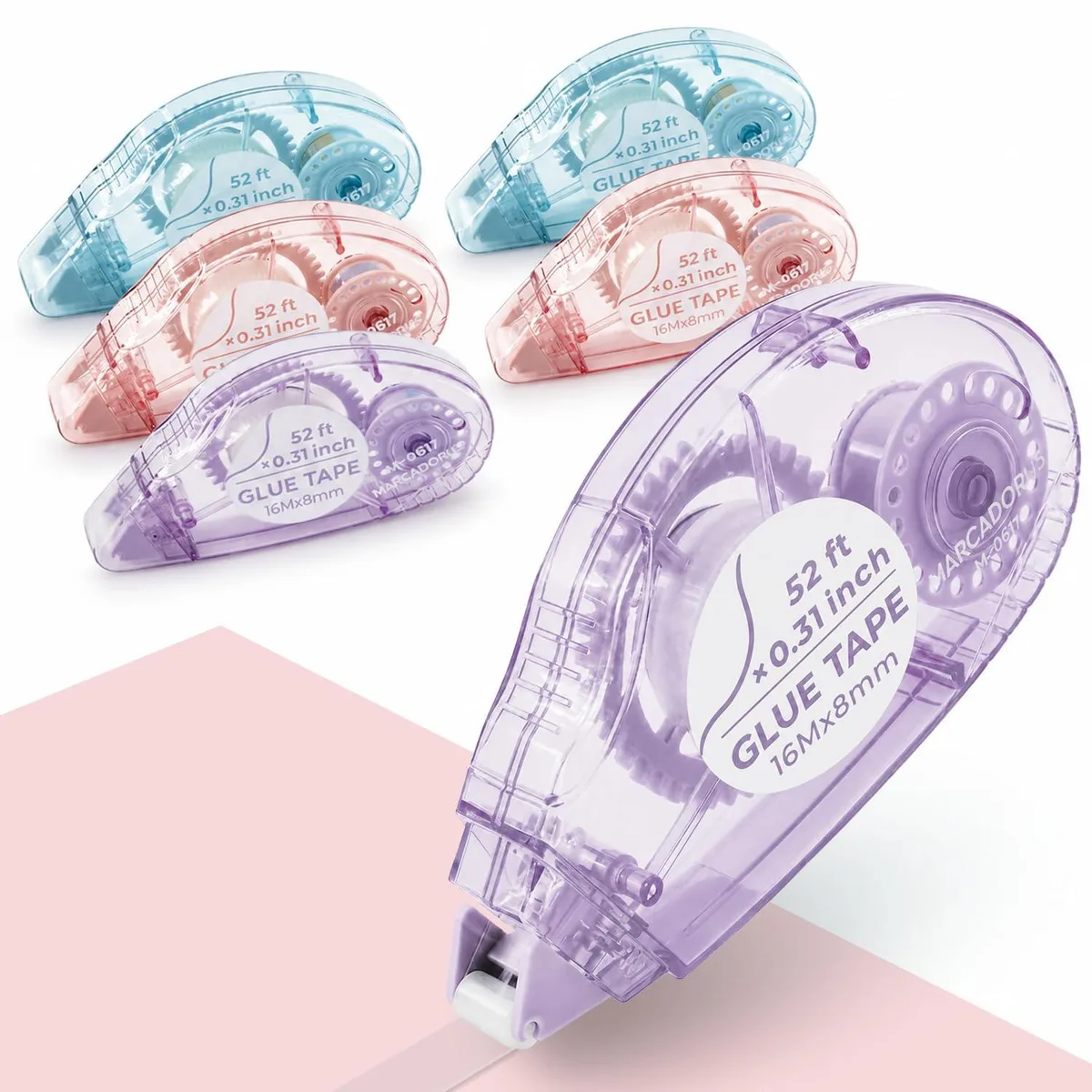 Six multicoloured tape rollers in clear housings with protective caps