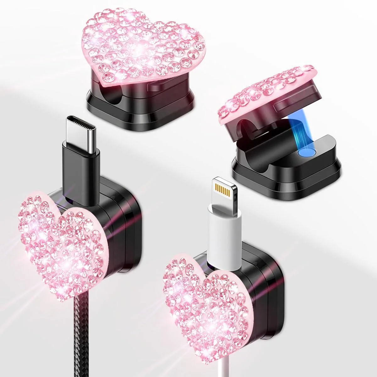 Four small pink heart-shaped cable clips on a surface