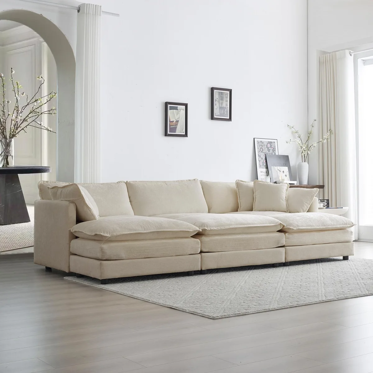 Beige chenille U-shaped sectional with three ottomans and five pillows