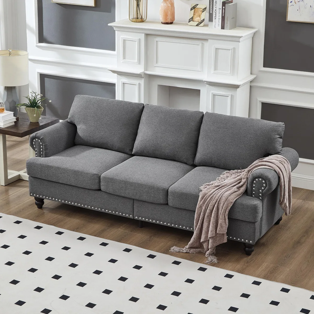Grey three-seater sofa with rolled arms and silver nailhead trim, polyester fabric, wooden legs