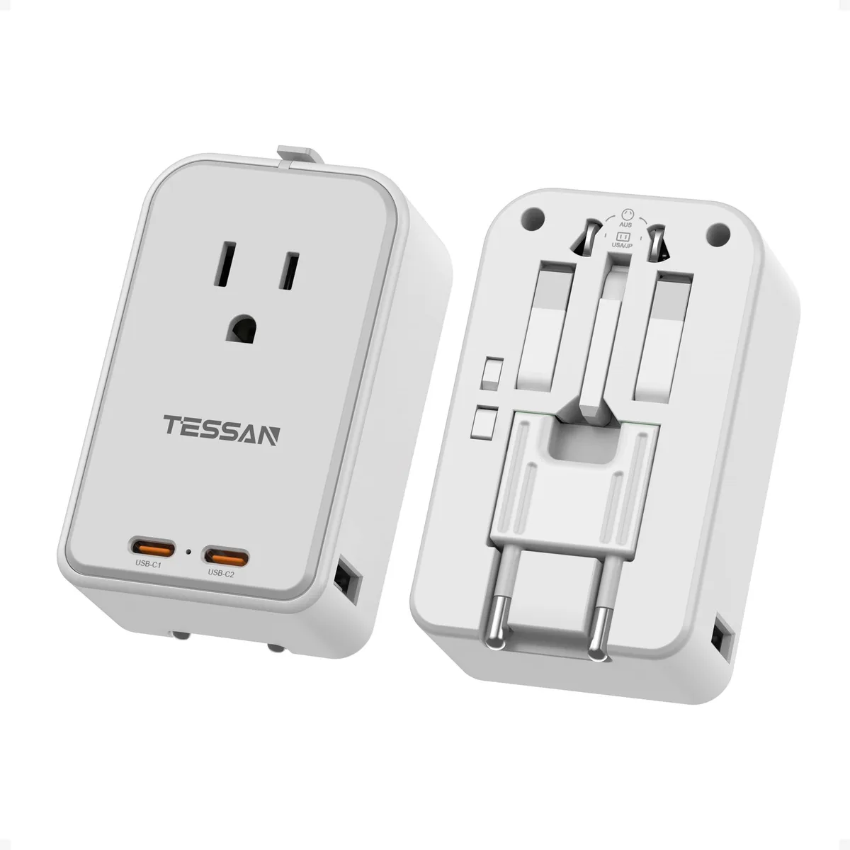 Grey rectangular travel adapter with sliding plug pins, one AC outlet and four USB ports