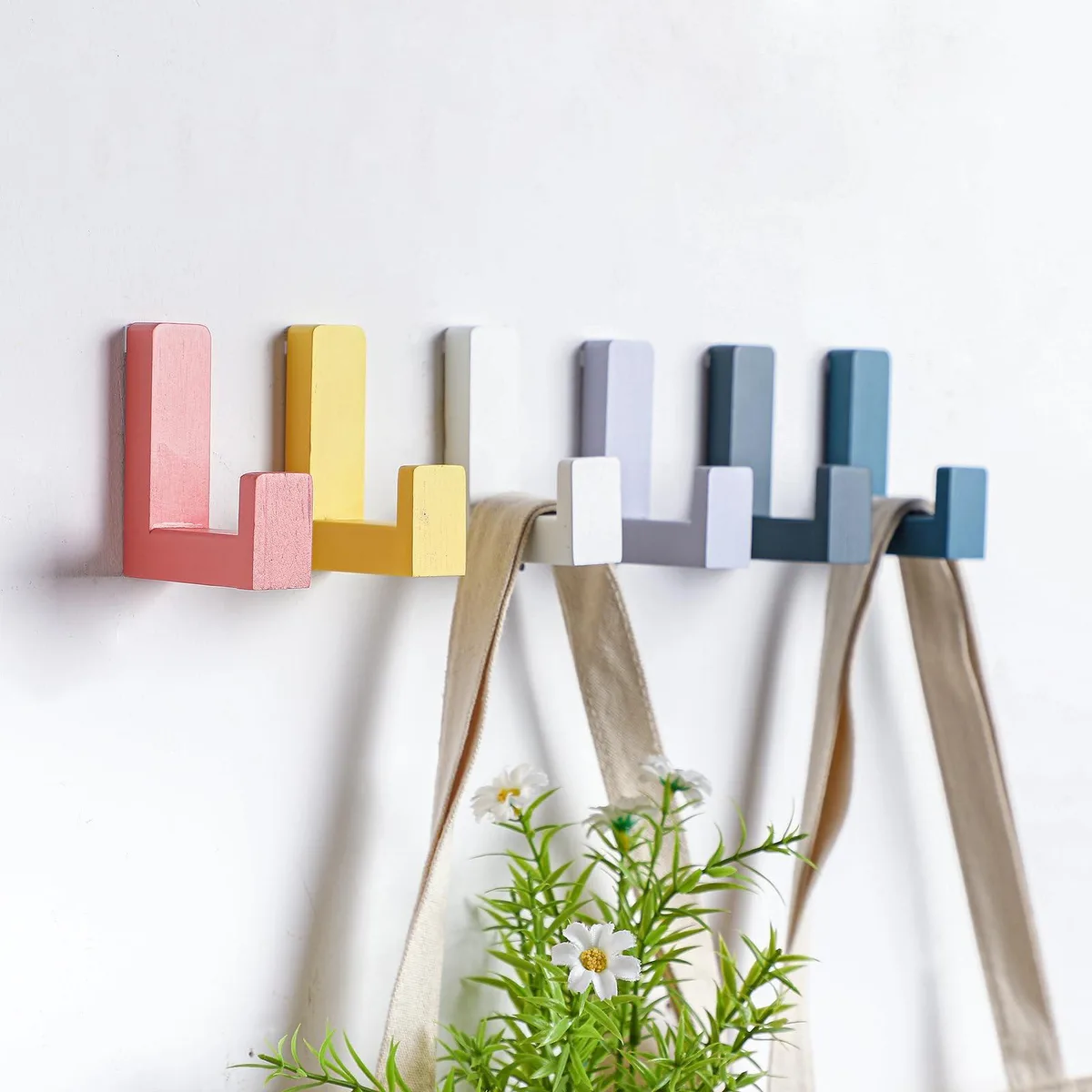 Six colourful wooden wall hooks in pastel shades with adhesive backing