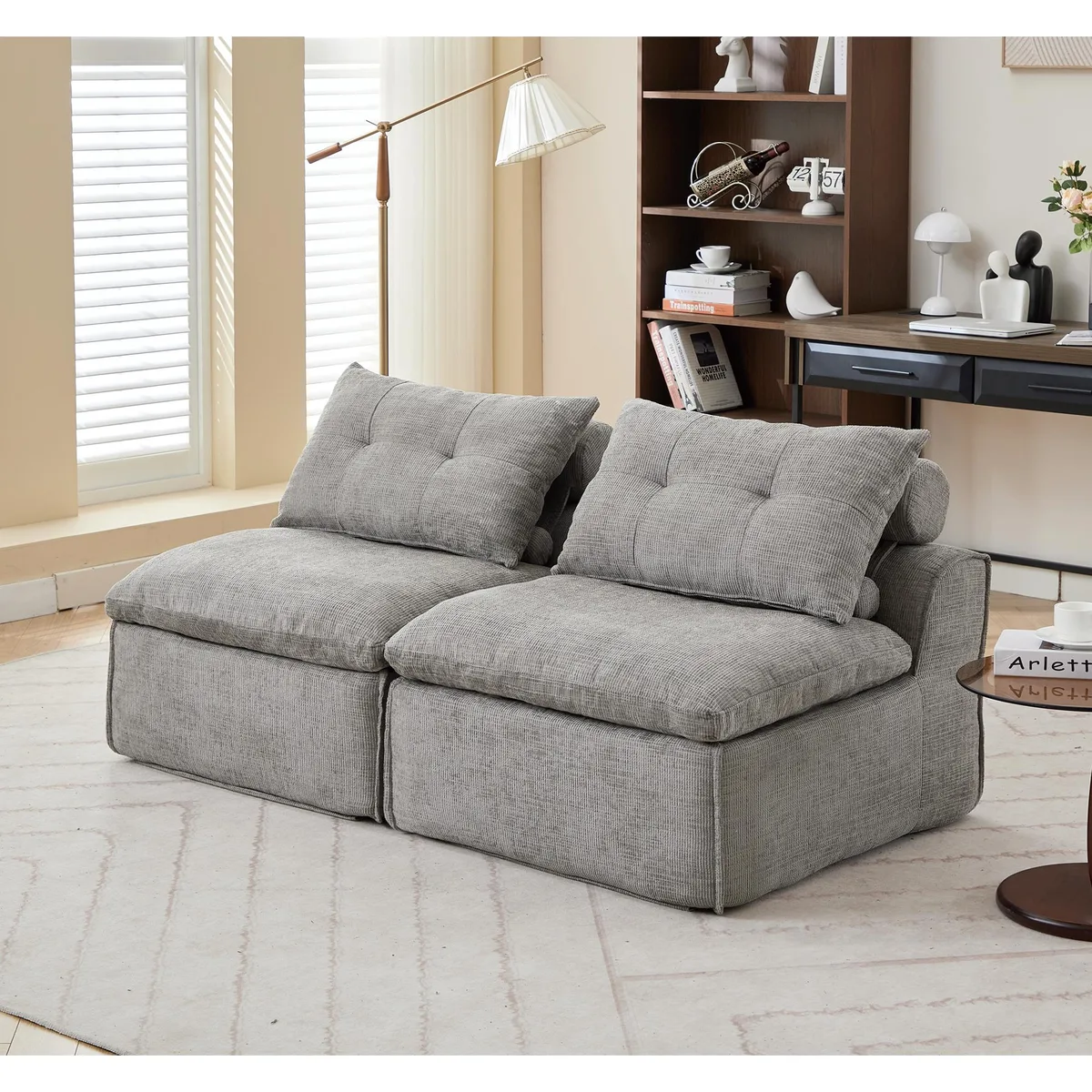 Light gray modular two seat sofa without armrests in chenille fabric with neck and lumbar pillows