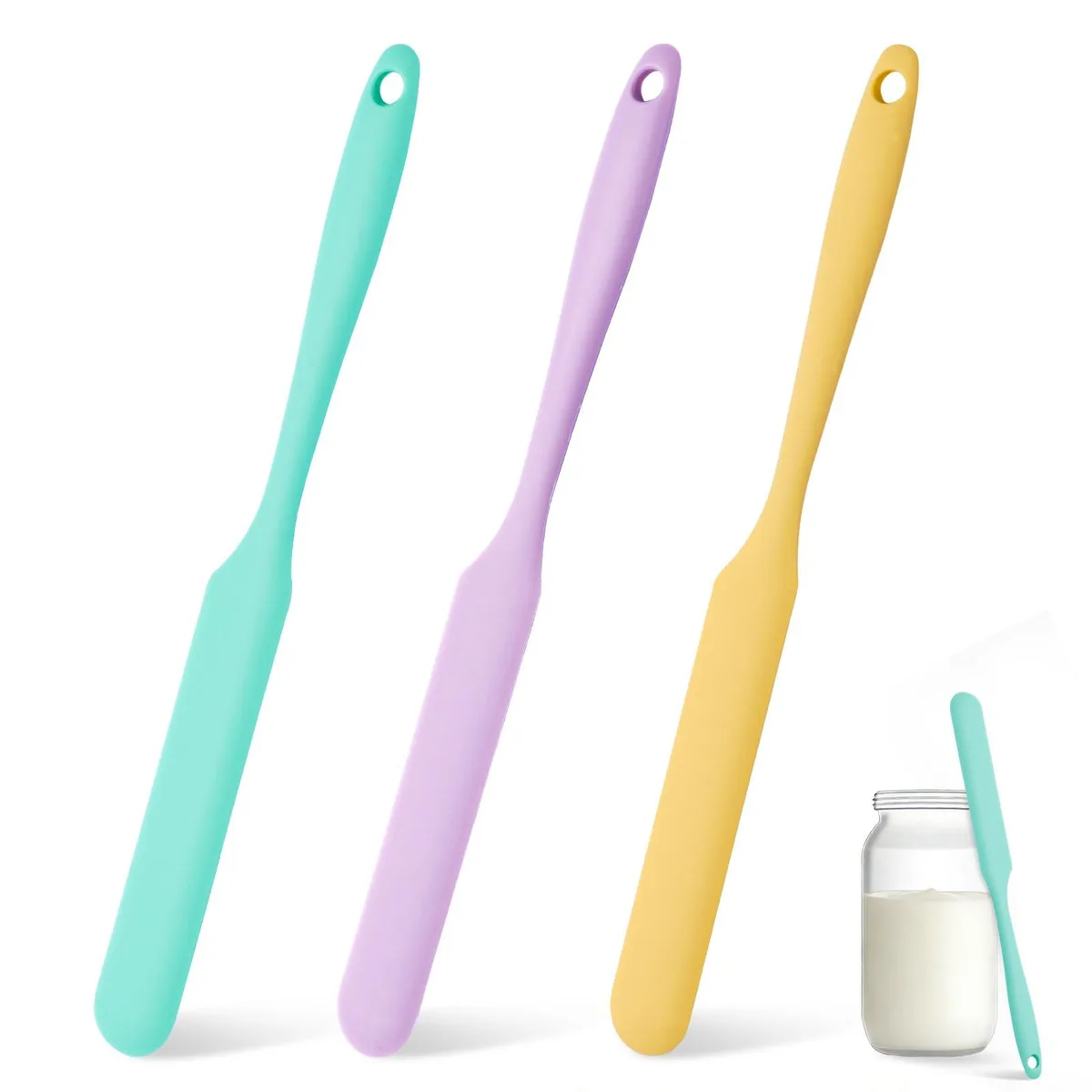 Three green silicone jar spatulas with long thin heads and integrated handles