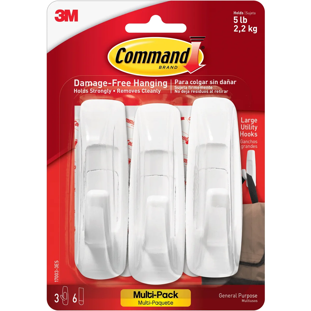 Three white plastic utility hooks with adhesive strips on a light background