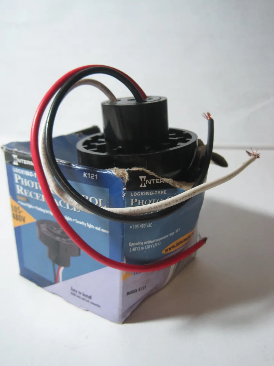 Black cylindrical locking photocontrol receptacle with 12 inch leads, 2.55 inch diameter, 1.52 inch height