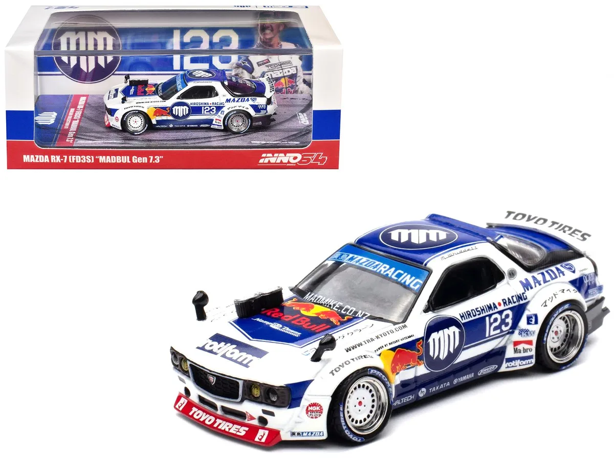 White and blue 1/64 scale Mazda RX-7 FD3S diecast model number 123 in plastic showcase